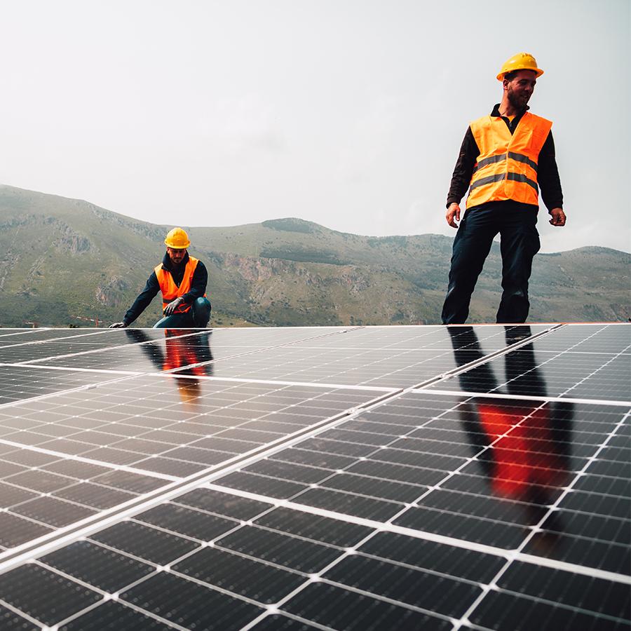 workers assemble energy system with solar panel